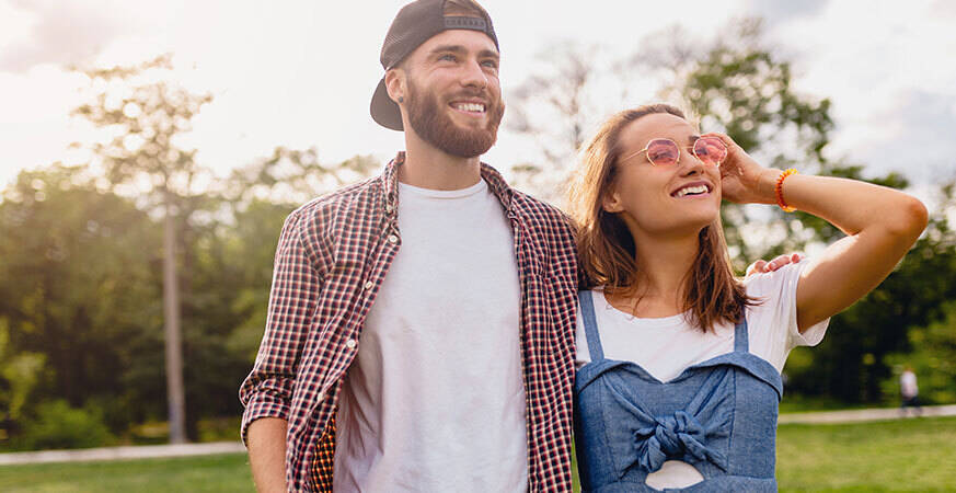 man and woman stretching their legs outdoors